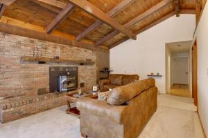 a living room with a couch and a fireplace at Waterfront Deck + Views: Schroon Lake Sanctuary in Schroon Lake