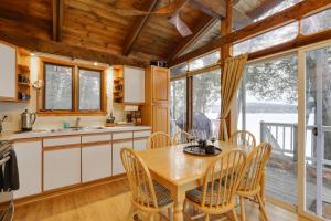 a kitchen and dining room with a table and chairs at Waterfront Deck + Views: Schroon Lake Sanctuary in Schroon Lake