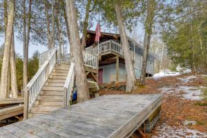 a house in the woods with a wooden deck at Waterfront Deck + Views: Schroon Lake Sanctuary in Schroon Lake