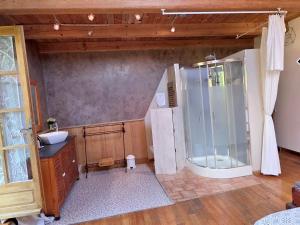 a kitchen with a refrigerator and a sink at Villanath in Bellegarde-sur-Valserine