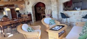 a living room with wicker chairs and a table at Villanath in Bellegarde-sur-Valserine
