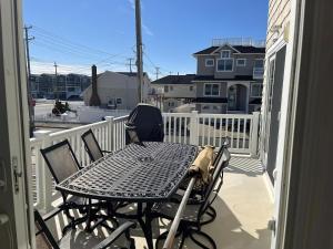 a patio table and chairs on a balcony at Bayside Gem in Beach Haven Crest