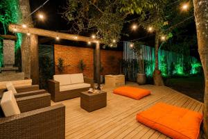 a wooden deck with furniture and lights on it at Refúgio nas Nuvens Ninho das Águias in Nova Petrópolis +59 photos
