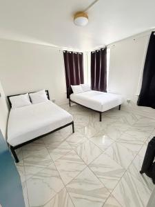 a room with two beds and a tiled floor at Adrian Hotel in San Francisco
