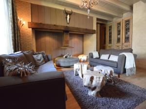 a living room with couches and a table at Alphen Retreat with Sauna in Alphen +19 photos