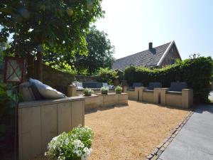 a backyard with chairs and a fence and a patio at Alphen Retreat with Sauna in Alphen