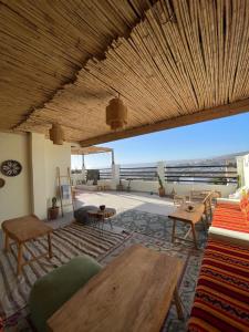 a living room with a table and a view at Coastal Haven Surf Morocco in Aourir +60 photos