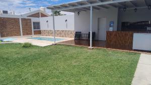 a backyard of a house with a pool and a screen at Casa bella vista in Pocito