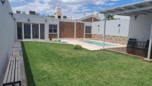 a backyard of a house with a swimming pool at Casa bella vista in Pocito
