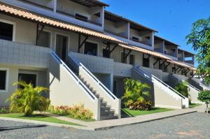 an apartment building with stairs in front of it at Casa 109 COND BRISAS DO FAROL n 07 in Salvador