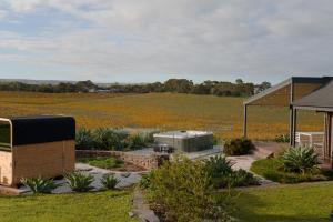 a garden with aestead and a field of flowers at Miravino, winery stay with outdoor sauna and spa in McLaren Vale
