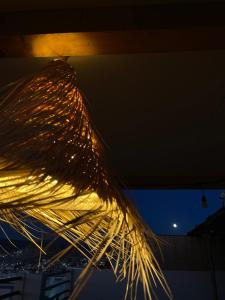 a bunch of lights hanging from a ceiling at night at Coastal Haven Surf Morocco in Aourir