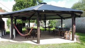 a gazebo with tables and chairs in a yard at El Refugio - Departamentos in Metán Viejo