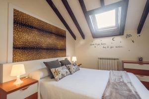 a bedroom with a white bed with a window at Apartamentos River Santander in Santander