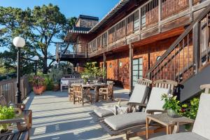 a deck with chairs and tables on a building at The Inn Above Tide in Sausalito