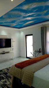 a bedroom with a bed and a sky painted on the ceiling at Niasha Gardens in Chinhoyi +23 photos