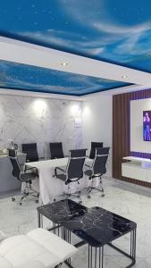 a conference room with chairs and a table and a screen at Niasha Gardens in Chinhoyi