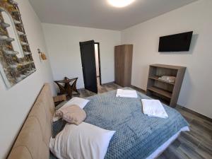 a bedroom with a bed with two towels on it at Apartamente VILLA 7 On The Beach in Eforie Nord +16 photos