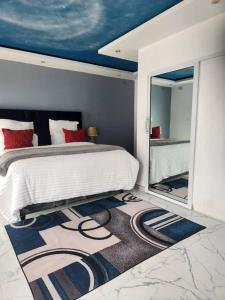 a bedroom with a large bed and a mirror at Niasha Gardens in Chinhoyi