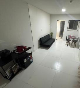 a living room with a couch and a table at Flat Lucidata in Feira de Santana +1 photo