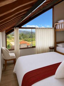 a bedroom with a bed and a large window at Mi Shalita in Santa Cruz