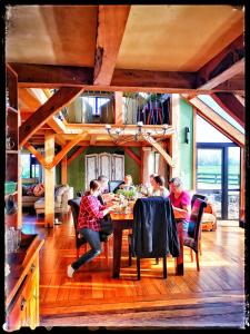 a group of people sitting around a table in a room at housewithnonails in Matamata