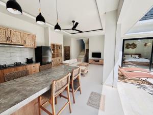 a kitchen and living room with a table and chairs at Lipah Beach Private Villas in Amed
