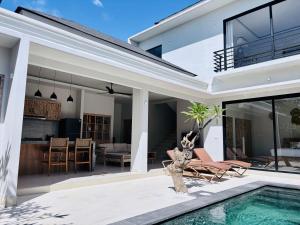 a home with a swimming pool and a house at Lipah Beach Private Villas in Amed