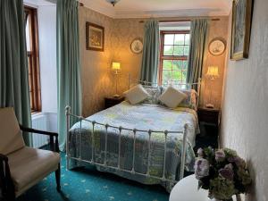 a bedroom with a bed and a chair and a window at Cavangarden House in Ballyshannon +22 photos