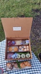 a box filled with different types of food on a table at Hospedagem de Charme Te Amo in Canela
