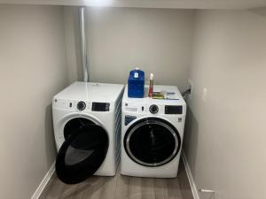 a washing machine and a washer in a room at Newly Renovated 2BR Walkout Suite in the Heart of Kanata Ottawa in Ottawa +3 photos