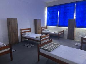 a dorm room with two beds and a window at Pousada Fortaleza SP 8 in São Paulo