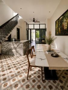 a kitchen and dining room with a table and chairs at Sonasea Vân Đồn - Centraltique Seaside in Quang Ninh