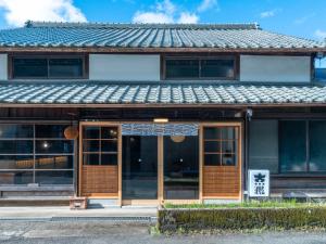 a building with a sign in front of it at 汐見屋 in Tanabe