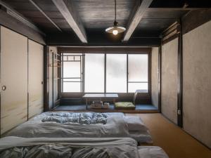 a large bed in a room with a large window at 汐見屋 in Tanabe