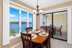 a dining room with a table and chairs and a large window at The Perch at Kimberling Crossing in Kimberling City