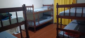 a room with three bunk beds in a room at Assel Pousada Xaxim in Curitiba +25 photos