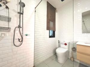 a white bathroom with a toilet and a shower at LECAR Home Shelby in Ban Nong Khang