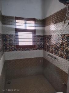 a bathroom with a shower with a window and a sink at AC Room Double Bed 1st floor House in Mohali