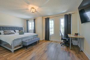 a bedroom with a bed and a desk with a computer at Harmony House in Richmond Hill