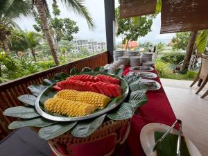 a table with a plate of corn on the cob at PP Mountain Beach Resort in Phi Phi Islands