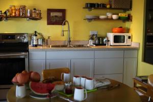 a kitchen with a table and a microwave at Casa Soza in White Water