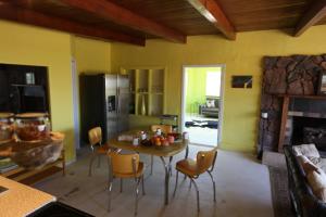a kitchen with a table and chairs and a fireplace at Casa Soza in White Water