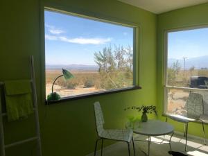 a green room with a table and a window at Casa Soza in White Water