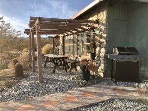 an outdoor patio with a grill and a picnic table at Casa Soza in White Water +19 photos