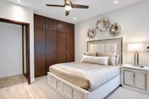 a bedroom with a bed and a ceiling fan at Casa Vista 133 in Cabo San Lucas +40 photos