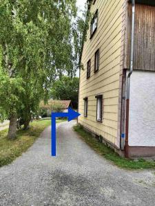 a blue arrow is standing next to a building at Relax in the Harz in Hasselfelde