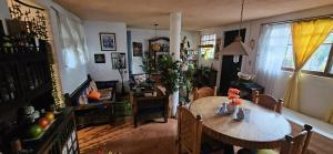 a living room with a wooden table and a dining room at Casa Lulú in Mexico City