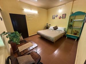 a small room with a bed and a chair at Mass Bungalow in Tindummal