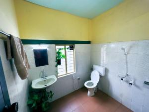 a bathroom with a sink and a toilet and a window at Mass Bungalow in Tindummal +92 photos